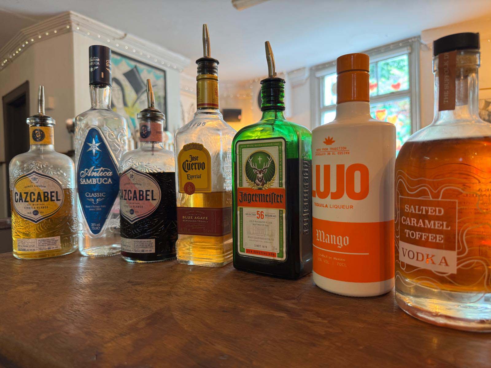Bottles of spirits lined up on bar